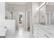 Bright main bathroom with marble countertop, double vanity, and glass shower at 135 Weeping Willow Way, Tyrone, GA 30290