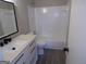 Bathroom featuring modern vanity and tub with white tile at 2401 Northlake Ct, Atlanta, GA 30345