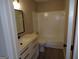 Bright bathroom featuring a modern vanity and shower-tub combo with tile surround at 2401 Northlake Ct, Atlanta, GA 30345