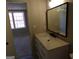 Stylish bathroom with a modern vanity, large mirror, and doorway view into bedroom at 2401 Northlake Ct, Atlanta, GA 30345