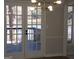 Dining area boasting French doors to outdoor deck, recessed lighting and a modern chandelier at 2401 Northlake Ct, Atlanta, GA 30345