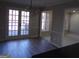 Dining area showcasing French doors, laminate flooring and modern light fixture at 2401 Northlake Ct, Atlanta, GA 30345