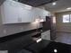 Modern kitchen featuring stainless steel appliances, white cabinetry, dark countertops, and updated fixtures at 2401 Northlake Ct, Atlanta, GA 30345