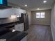 Modern kitchen with stainless steel appliances, white cabinetry, black countertops, and new flooring at 2401 Northlake Ct, Atlanta, GA 30345