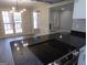 Granite countertops with island cooktop overlooking dining and living spaces at 2401 Northlake Ct, Atlanta, GA 30345