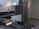 Modern kitchen with stainless steel appliances, white cabinetry, black countertops, and updated fixtures at 2401 Northlake Ct, Atlanta, GA 30345