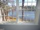Bright view of a beautiful lake from a window with a white frame in this home's interior at 2401 Northlake Ct, Atlanta, GA 30345