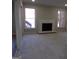 Spacious carpeted living room with a white brick fireplace, windows and doorway at 2401 Northlake Ct, Atlanta, GA 30345