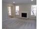 Inviting living room features a cozy fireplace and views of the outdoors through two large windows at 2401 Northlake Ct, Atlanta, GA 30345