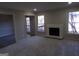 Large living room with a brick fireplace, ample natural light and view into another room at 2401 Northlake Ct, Atlanta, GA 30345
