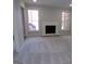 Open living space with a white brick fireplace and large windows providing natural light at 2401 Northlake Ct, Atlanta, GA 30345