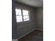 Picture of a room with laminate flooring, grey walls, and a window letting in natural light at 2401 Northlake Ct, Atlanta, GA 30345