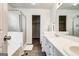 Bright bathroom featuring a double vanity, walk-in shower, and wood look flooring at 2561 Rainover Ct, Decatur, GA 30034