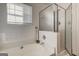 Well-lit bathroom featuring a soaking tub with tile surround and a separate glass-enclosed shower at 2561 Rainover Ct, Decatur, GA 30034