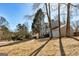 Well-maintained two-story home with neutral siding, an attached garage, and a long driveway in a wooded setting at 2561 Rainover Ct, Decatur, GA 30034