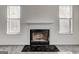 Close-up of the fireplace with a mantle between two large windows at 2561 Rainover Ct, Decatur, GA 30034