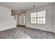 Inviting living room featuring a large window and adjacent staircase to upper level at 2561 Rainover Ct, Decatur, GA 30034