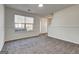 Cozy living room with plush carpeting, window, and direct access to the front door at 2561 Rainover Ct, Decatur, GA 30034