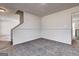 Spacious living room features plush carpeting and entrance to the stairwell and kitchen at 2561 Rainover Ct, Decatur, GA 30034