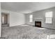 Living room featuring a fireplace, two large windows, and an open doorway to other rooms at 2561 Rainover Ct, Decatur, GA 30034