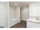 Bright bathroom featuring a soaking tub with shower and vanity with a stone countertop at 275 Oliver Dr, Locust Grove, GA 30248