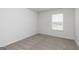 Vacant bedroom featuring neutral walls and carpet with a window providing natural light at 275 Oliver Dr, Locust Grove, GA 30248