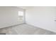 Bedroom showcasing neutral carpet and walls, brightened by a window for natural light at 275 Oliver Dr, Locust Grove, GA 30248