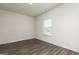 Bright bedroom with hardwood floors, neutral walls, and a window providing natural light at 275 Oliver Dr, Locust Grove, GA 30248