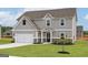 Charming two-story home with gray siding, white trim, attached garage and lush green lawn at 275 Oliver Dr, Locust Grove, GA 30248