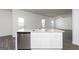 Well-equipped kitchen with stainless steel dishwasher, white cabinets, and granite countertops at 275 Oliver Dr, Locust Grove, GA 30248