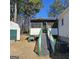 Backyard featuring a screened in porch, shed, and air conditioner at 4748 Ash St, Doraville, GA 30340