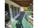 The front porch is green and white with an exterior light and some windows at 4748 Ash St, Doraville, GA 30340