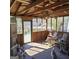 A screened porch featuring rocking chairs and a wood ceiling at 4748 Ash St, Doraville, GA 30340