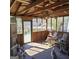 Screened porch with wooden ceiling and rocking chairs at 4748 Ash St, Doraville, GA 30340