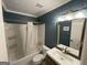 Bathroom with shower and tub combination, painted blue walls, and modern fixtures at 3370 Creek Hollow Dr, Marietta, GA 30062