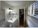 Bathroom featuring a vanity with a round mirror and three-light fixture at 3370 Creek Hollow Dr, Marietta, GA 30062