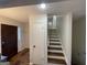 Entryway of home with door, coat rack, hardwood floors, and staircase to the second level at 3370 Creek Hollow Dr, Marietta, GA 30062