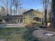 Exterior view of the home from the backyard with a charming fire pit at 3370 Creek Hollow Dr, Marietta, GA 30062