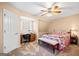 Bedroom featuring a desk, a bed and a bench and a ceiling fan with light at 444 Pineview Dr, Canton, GA 30114