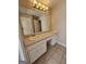 Bathroom vanity featuring a sink, large mirror, and ample storage space at 245 Kim Trail, Stockbridge, GA 30281