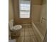 Bathroom with a standard toilet, tile flooring, and a bathtub at 245 Kim Trl, Stockbridge, GA 30281