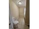 Neutral bathroom featuring tile flooring, a toilet, towel bar, and a window providing natural light at 245 Kim Trail, Stockbridge, GA 30281