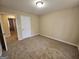 Bedroom with neutral carpeting, a window, and a closet at 245 Kim Trail, Stockbridge, GA 30281