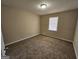 Bedroom featuring neutral carpet and a window, offering a comfortable space at 245 Kim Trl, Stockbridge, GA 30281