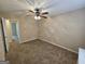 Bedroom with neutral walls, carpet, and a ceiling fan, offering a comfortable retreat at 245 Kim Trl, Stockbridge, GA 30281