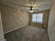 Bedroom with neutral walls, carpet, a ceiling fan, and a window bringing in natural light at 245 Kim Trail, Stockbridge, GA 30281