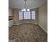 Bright dining area featuring a chandelier and window-lined walls, carpeted flooring, and neutral walls at 245 Kim Trl, Stockbridge, GA 30281