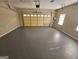 Empty garage with freshly painted epoxy floor and a garage door at 245 Kim Trl, Stockbridge, GA 30281