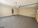 Clean, empty garage with an epoxy floor, utility door and garage door at 245 Kim Trail, Stockbridge, GA 30281