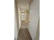 Hallway with neutral walls, carpet, and white doors providing access to multiple rooms at 245 Kim Trail, Stockbridge, GA 30281